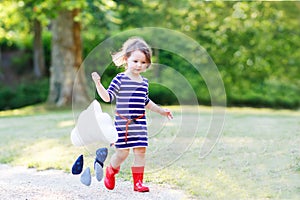 Mother and little adorable child in yellow rubber boots