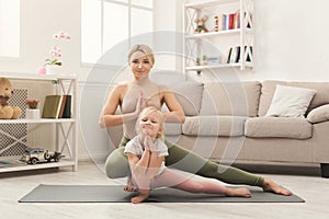 Mother and little daughter doing yoga together