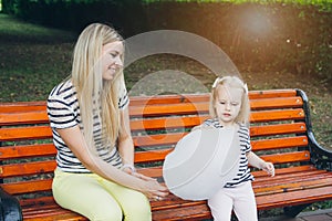 Mother and little daughter eating cotton candy