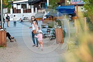 Mother and little daughter having fun on the beach. Authentic lifestyle image