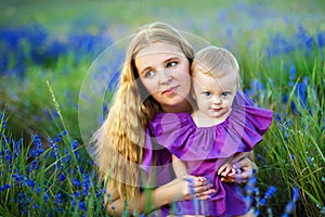 Mother and little daughter playing together in a park