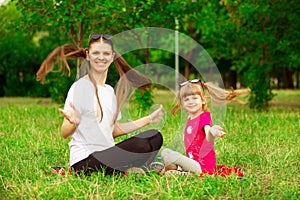 Mother and little daughter playing together in park. Outdoor Portrait of happy family. Happy Mother`s Day Joy.