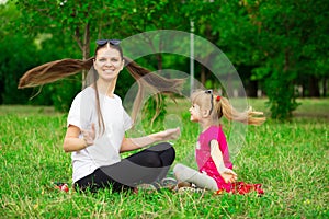 Mother and little daughter playing together in park. Outdoor Portrait of happy family. Happy Mother`s Day Joy.