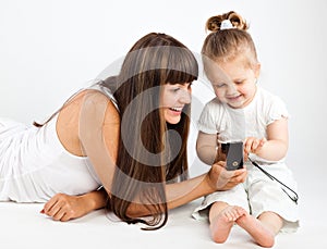 Mother and little daughter speaking by phone