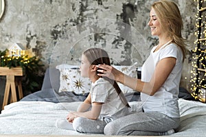 Mother and little daughter spending morning at home