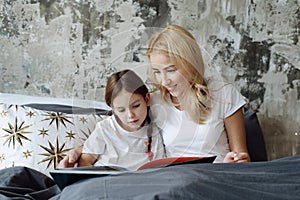 Mother and little daughter spending morning at home