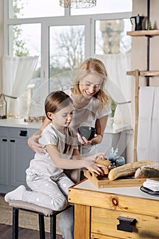 Mother and little daughter spending morning at home