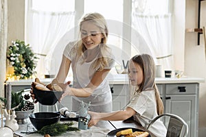 Mother and little daughter spending morning at home