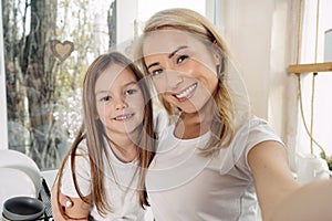 Mother and little daughter spending morning at home