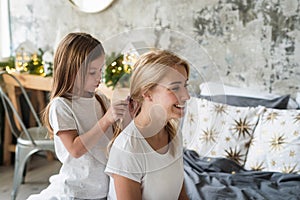 Mother and little daughter spending morning at home