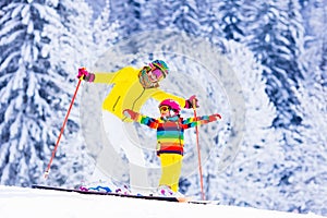 Mother and little girl learning to ski