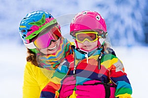 Mother and little girl learning to ski