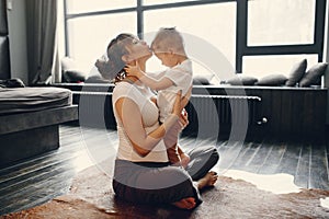 Mother with little son doing yoga at home