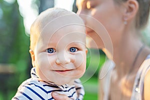 Mother and little son outdoors. Mom and baby boy having fun together in green garden or park. Happy family, child and parenthood c