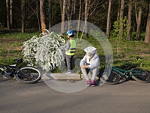 mother and little son ride bicycles on a spring sunny day