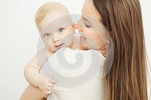 Mother looks at child with care love, baby on arms