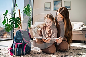 Mother looks at her daughter`s grades in the school diary.