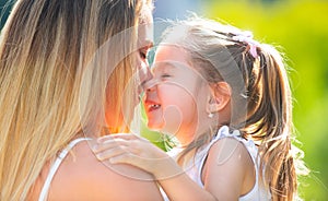 Mother love. Mother and child girl playing kissing and hugging. Little daughter hugging her happy mother.