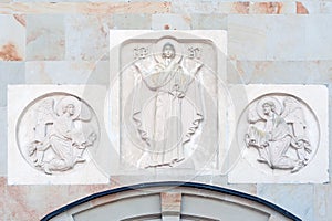 Mother Mary and angels stone decorations on the wall