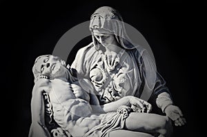 Mother Mary with the dead Jesus in her arms. Dark background. Special tone effect concept of death