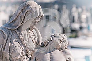 Mother Mary with the dead Jesus in her arms. Dark background. Tone effect concept of death, self-sacrifice