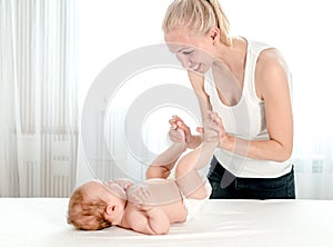 Mother massaging her infant baby