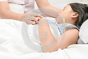 Mother measuring temperature of her ill kid