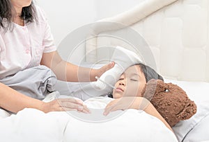 Mother measuring temperature of her ill kid.