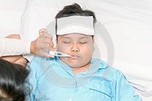 Mother measuring temperature of ill kid. Sick child with high fever