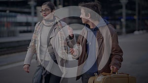 Mother Meeting Son at Train Station Talking Together after a long time