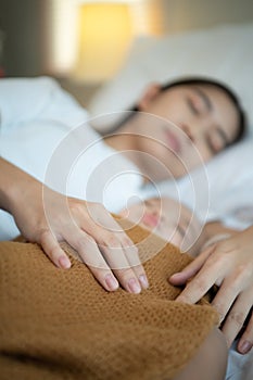 A mother must sleep and rest with her newborn baby. In the white bedroom, warm sunlight in the evening of the day