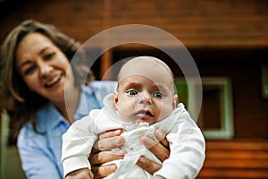 Mother And Newborn Baby with blue eyes Family Portrait, Mom Embracing New Born Kid