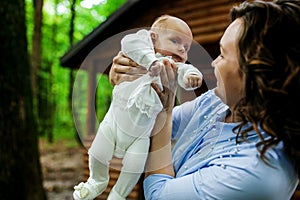 Mother And Newborn Baby with blue eyes Family Portrait, Mom Embracing New Born Kid