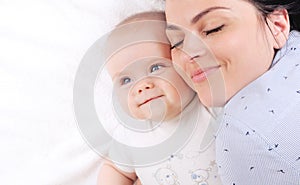 Mother with newborn baby sleeping on the bed at home