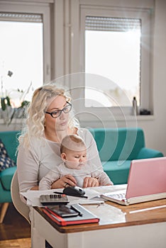 Mother opening envelope at home office