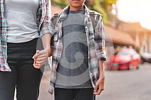 Mother or parent holding hand son or pupil with backpack go to school, Back to school concept, Selective focus