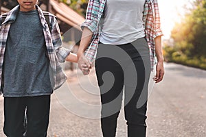 Mother or parent holding hand son or pupil with backpack go to school, Back to school concept, Selective focus