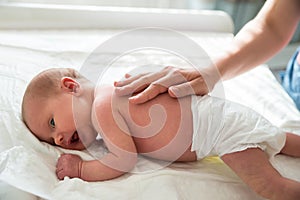 Mother Patting On Baby`s Back