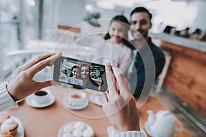 Mother Photographs Dad with Daughter on Cellphone