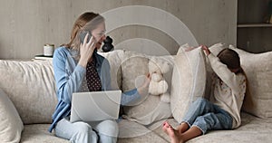 Mother play with daughter while working from home during quarantine