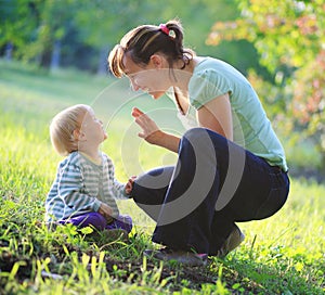 Mother play with her baby outdoor