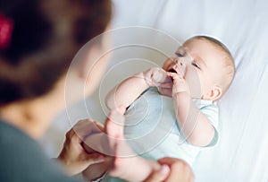 Mother playing with adorable happy baby