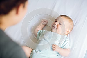 Mother playing with adorable happy baby