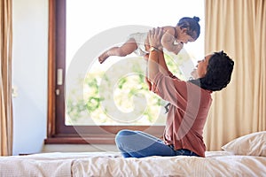 Mother playing baby daughter bed room carrying lifting fun bonding. Mother playing baby daughter bed room carrying