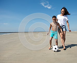 Mother playing with ball together with son