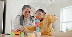 Mother playing with building blocks with her girl kid in the kitchen for child development at home. Happy, bonding and