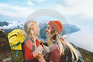 Mother playing with daughter child outdoor hiking in Norway together happy family lifestyle traveling in mountains