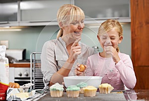 Mother playing, flour or child baking in kitchen or happy family with an excited girl learning cupcake recipe. Home