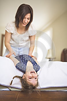 Mother playing with her baby in the bedroom