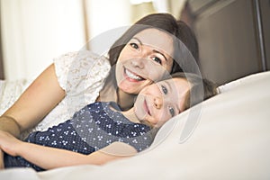 Mother playing with her baby in the bedroom